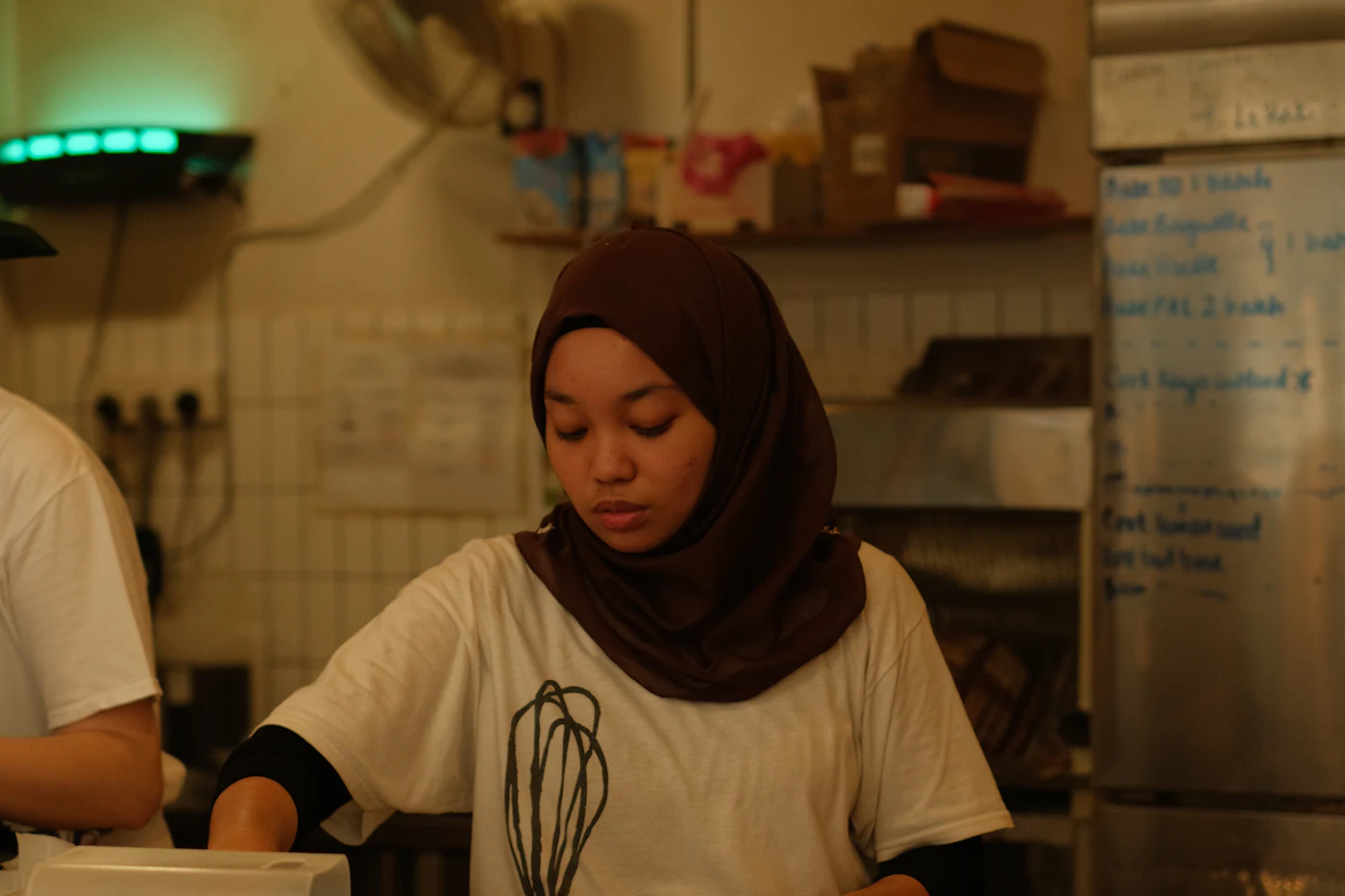 A café worker preparing an order at the counter